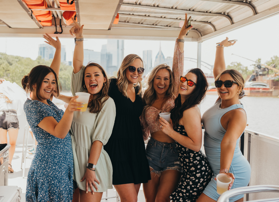 group of friends smiling on bachelorette party cruise