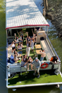 aerial view of people waving from the pontoon boat