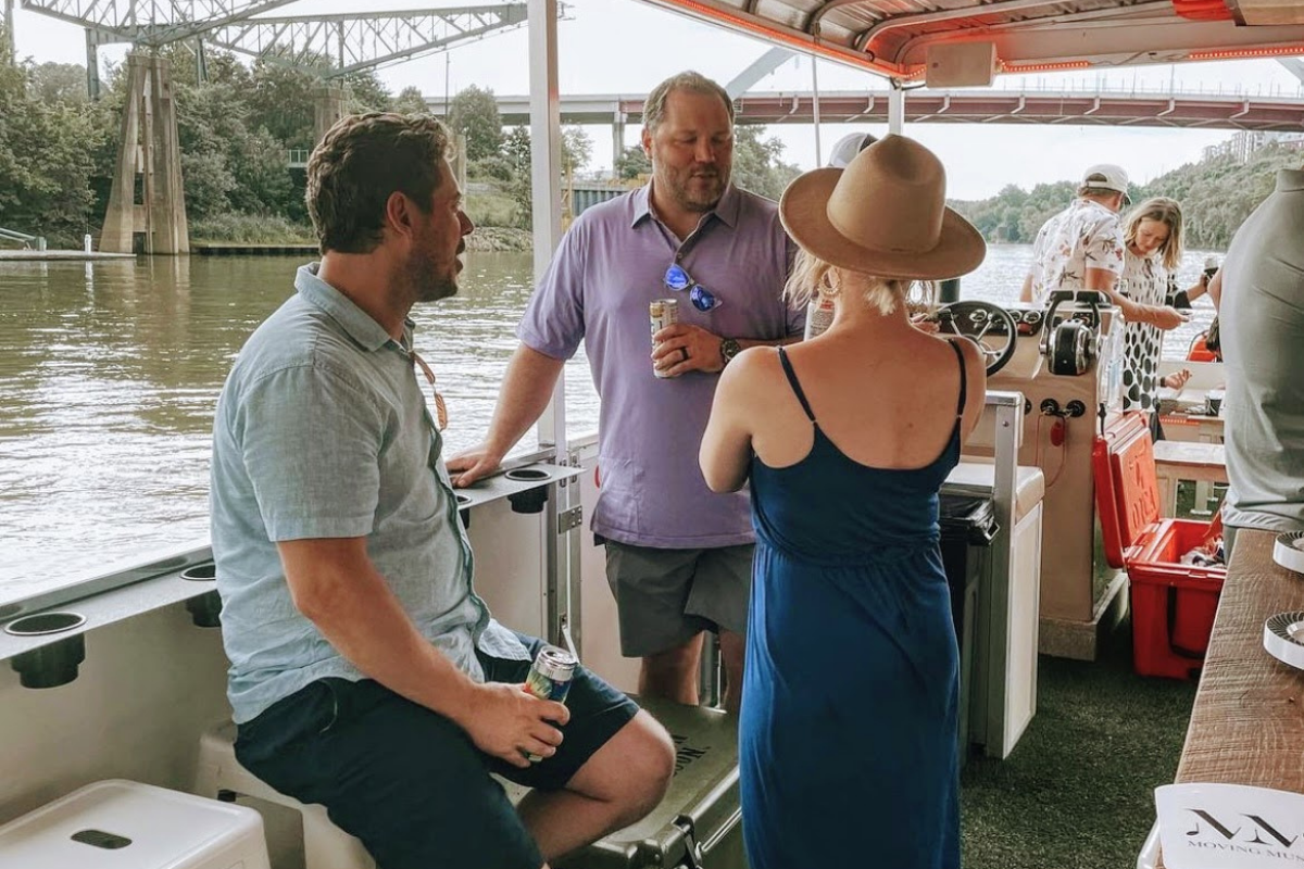 coworkers talking while at a work event on pontoon saloon