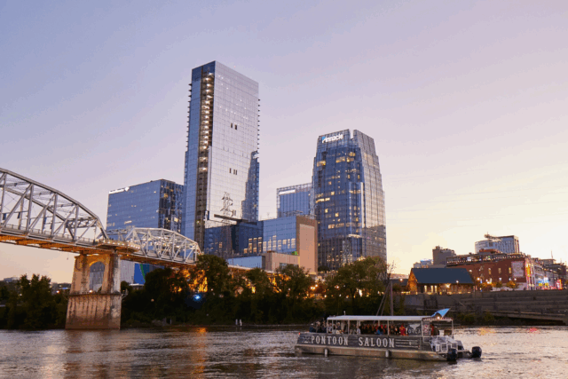 pontoon saloon cruising by the nashville skyline at sunset