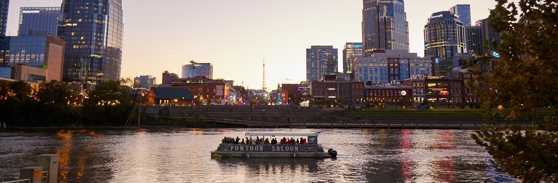 a private boat party cruising in front of evening nashville skyline
