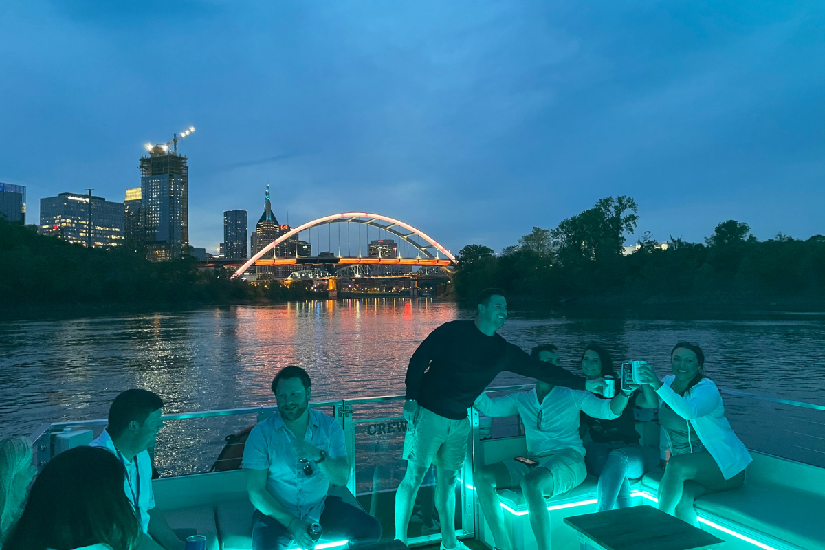 people on evening river cruise in glowing blue lights