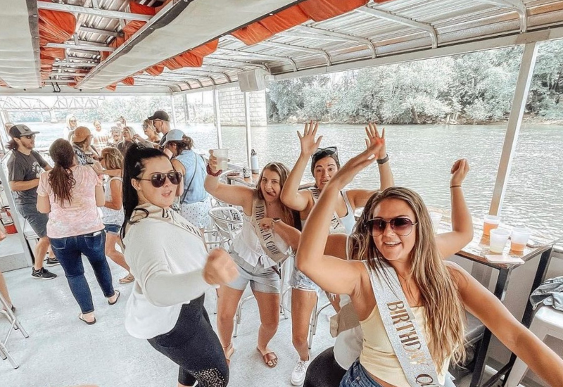 ladies dancing on a pontoon party cruise