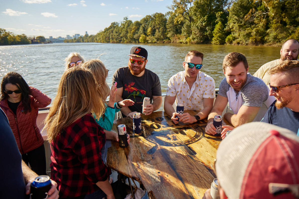 group laughing around table while cruising the river