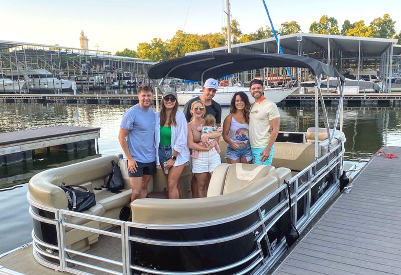 family smiling on a pontoon boat rental