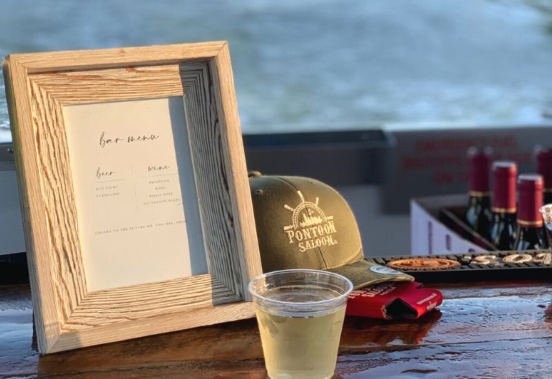 bar menu with glass of wine and pontoon saloon hat