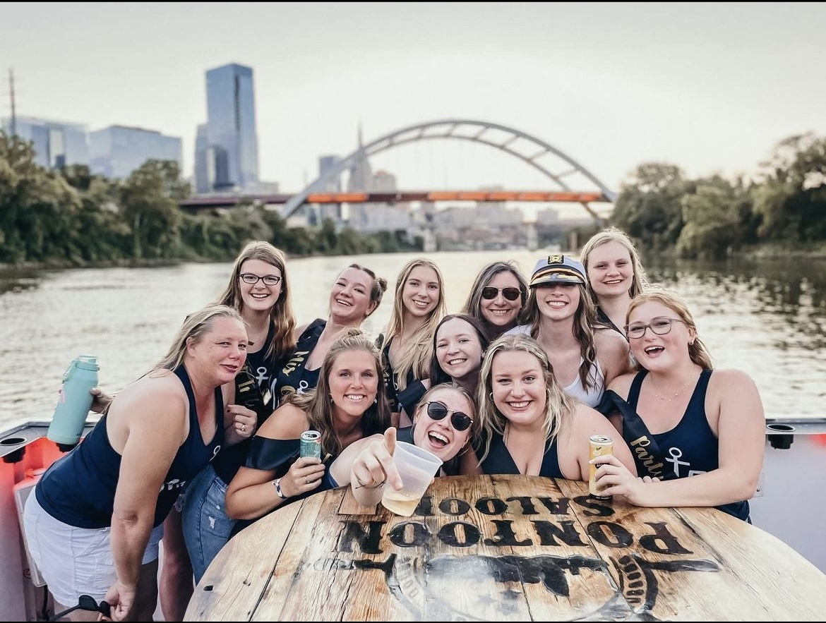 bachelorette party posing with city background