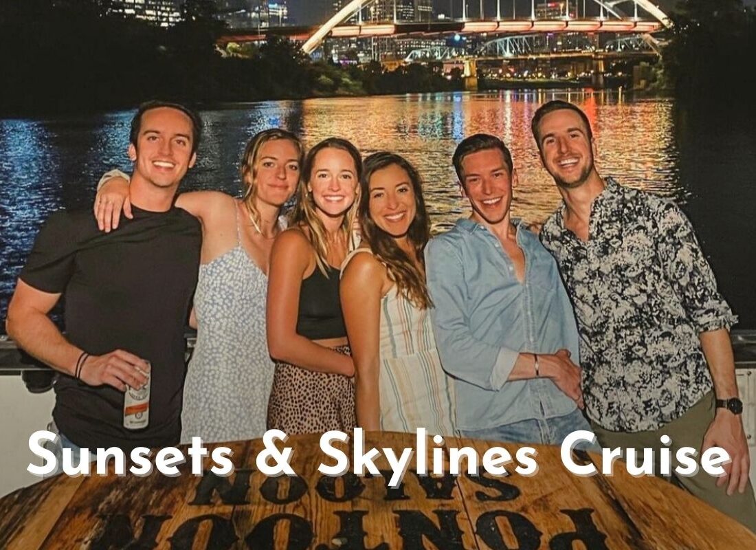 group of friends smiling on an evening river cruise
