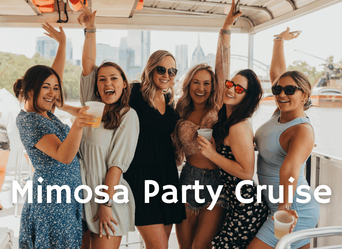 group of women with their hands in the air smiling on a bachelorette party in nashville