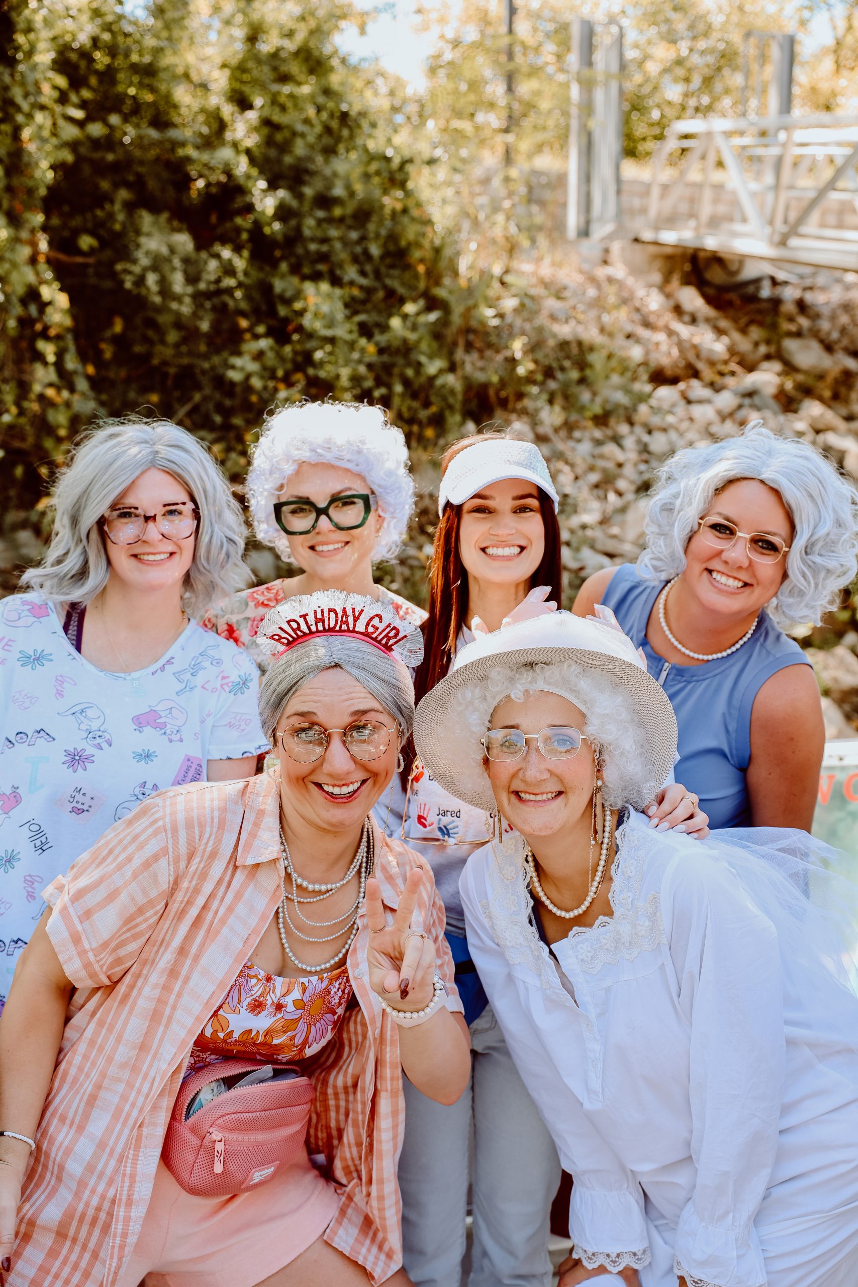 Group in matching grandma costumes on the dock