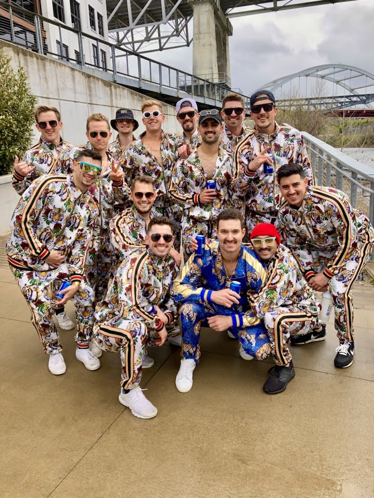 Group in matching tiger-print tracksuits on the riverfront